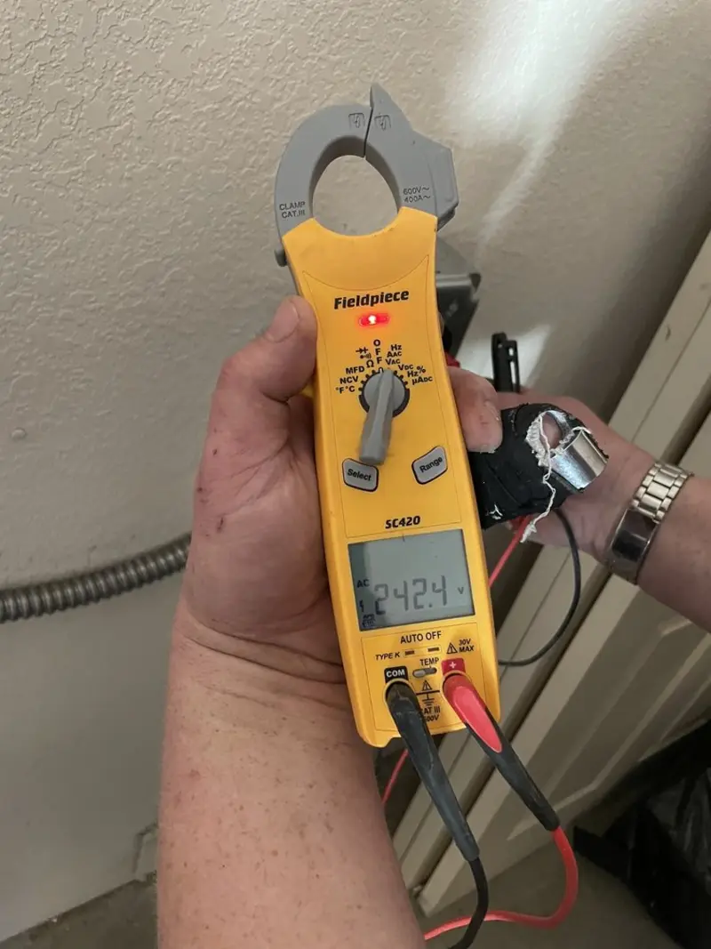 Voltage testing with clamp meter during Recessed Lighting Installation in Citronelle